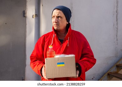 Volunteer Preparing Food Box For Ukrainian War Refugees - Humanitarian Help And Aid Concept.