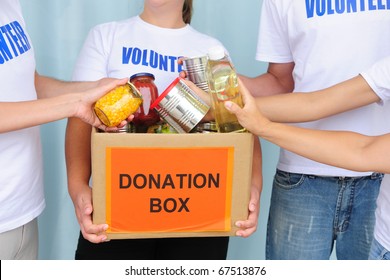 Volunteer Putting Food In A Donation Box