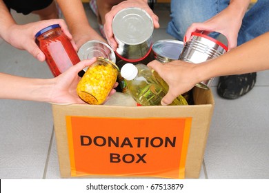 Volunteer Putting Food In A Donation Box