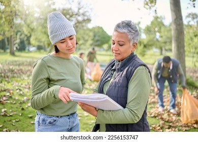 Volunteer schedule, community cleaning and charity work outdoor with women planning a project. Recycle team, collaboration and eco friendly job with people checking volunteering data in a park - Powered by Shutterstock