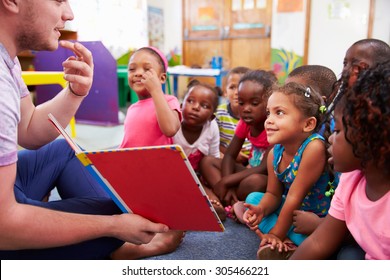 Volunteer teacher reading to a class of preschool kids - Shutterstock ID 305466221