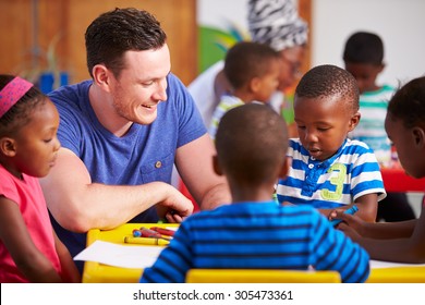 Volunteer teacher sitting with preschool kids in a classroom
