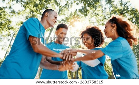 Volunteer, team or people stack hands for support, donation goal or cooperation in low angle outdoor. Huddle together, community service or group at charity NGO, smile or motivation for collaboration