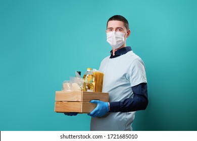 Volunteer Wearing Medical Glovesand Mask Holds Food Box. Concept Of Donations, Support And Volunteering.