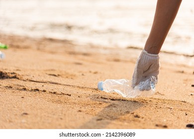 Volunteer Woman Picking Plastic Bottle Into Trash Plastic Bag Black For Cleaning The Beach, Female Clean Up Garbage, Ecology Concept And World Environment Day, Save Earth Concept