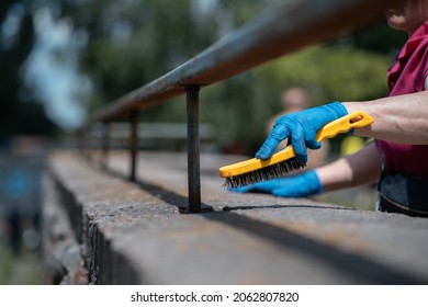 Volunteer Worker Painting And Renovate Railing Or Fence In Public Park