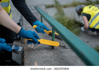 Volunteer Worker Painting And Renovate Railing Or Fence In Public Park