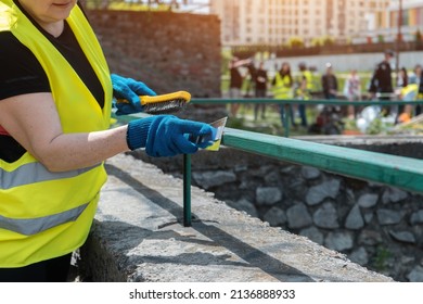 Volunteer Worker Painting And Renovate Railing Or Fence In Public Park