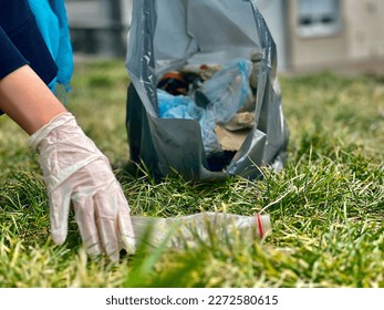 Volunteer young woman collecting garbage - Powered by Shutterstock