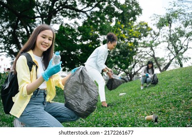 Volunteering, charity and clean environment concept.Multiethnic diversity woman group of volunteers with garbage bags cleaning city park.Beautiful Asian and African Female Students collecting garbage  - Powered by Shutterstock