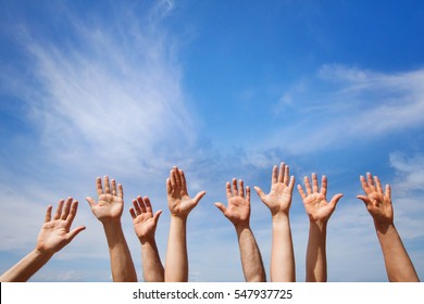 volunteering concept, hands of group of people volunteers in blue sky - Shutterstock ID 547937725