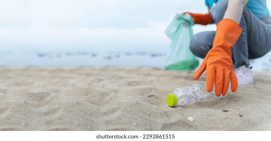 volunteering,charity,microplastic,cleaning,people picking up plastic bottle cleaning on the beach.,agriculture and climate change,microplastic waste.food industry and plastic packaging.  - Powered by Shutterstock