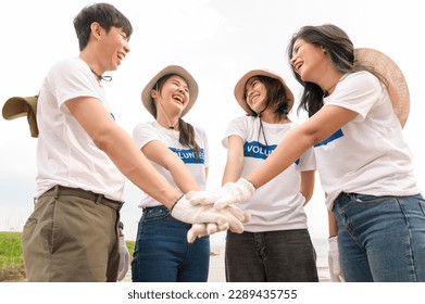 Volunteers from the Asian youth community using rubbish bags cleaning  up nature par - Powered by Shutterstock