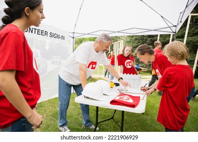 Volunteers checking in near construction frame - Powered by Shutterstock