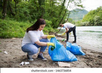 Volunteers Cleaning Plastic At River Beach