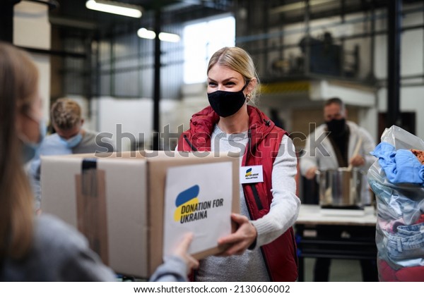 Volunteers collecting donations\
for the needs of Ukrainian migrants, humanitarian aid\
concept.