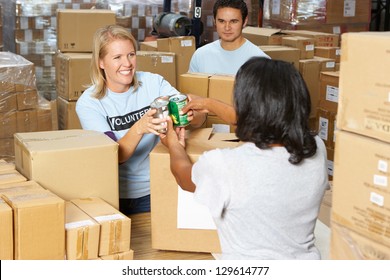 Volunteers Collecting Food Donations In Warehouse