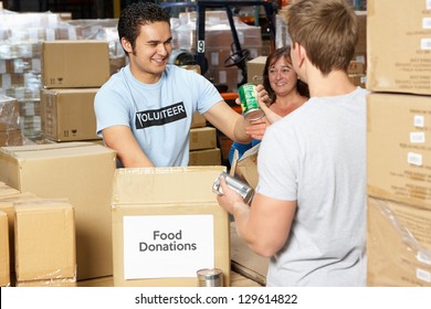 Volunteers Collecting Food Donations In Warehouse