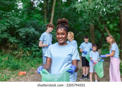 Volunteers collecting garbage from park, environmental awareness is important to save our planet - Powered by Shutterstock