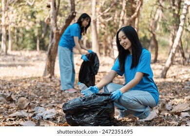 Volunteers Collecting Trash in Forest, Eco-Friendly Community Service, Environmental Conservation, Young People Cleaning Nature, Sustainable Living, Outdoor Cleanup, Teamwork in Nature, Green - Powered by Shutterstock