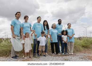 Volunteers collecting waste stand to show their power, cooperation, a team of garbage collectors working together, an environmental business idea - Powered by Shutterstock