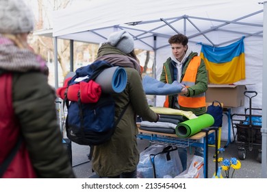 Volunteers distributing blankets and other donations to refugees on the Ukrainian border. - Shutterstock ID 2135454041