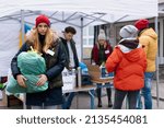 Volunteers distributing dontaions to refugees on the Ukrainian border, Russian-Ukrainian war concept.