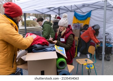 Volunteers distributing dontaions to refugees on the Ukrainian border, Russian-Ukrainian war concept.