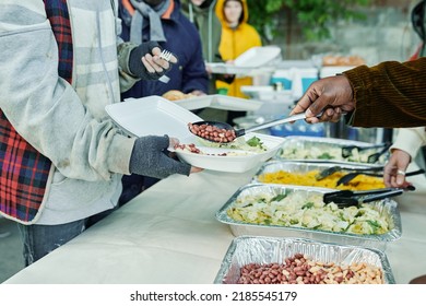 Volunteers Feeding Homeless People Outdoors