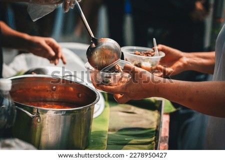 Volunteers give food to the poor, share free food to help beggars. food donation concept