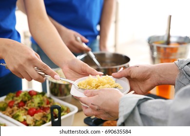 Volunteers Giving Food To Poor People. Poverty Concept