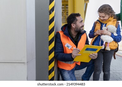 Volunteers Helping Ukrainian Refugee Family At Train Station, Filling Forms.