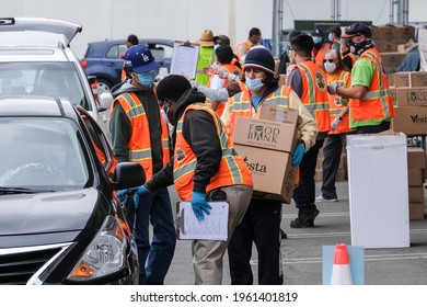 Volunteers Load Food Into The Trunk Of Vehicles During A ''Let's Feed L.A. County'' Drive Thru Food Distribution By The Los Angeles Regional Food Bank, April 23, 2021, In Rosemead, California.