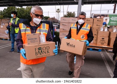 Volunteers Load Food Into The Trunk Of Vehicles During A ''Let's Feed L.A. County'' Drive Thru Food Distribution By The Los Angeles Regional Food Bank, April 23, 2021, In Rosemead, California.