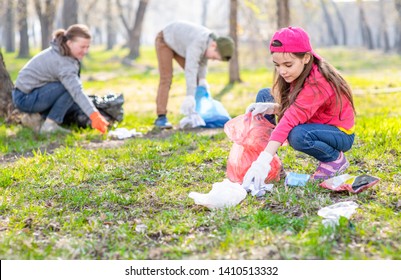 Volunteers Picking Up Trash In The Park. Ecology Concept.