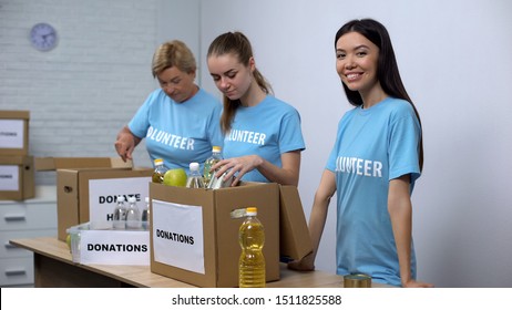 Volunteers Putting Food In Donation Boxes, Charity Funds To Help People In Need