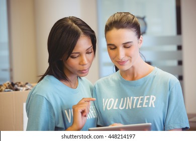 Volunteers using a tablet in the office - Powered by Shutterstock