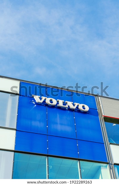 Volvo brand\
logo on bright blue sky background located on its sale office\
building in Lyon, France - February 23,\
2020