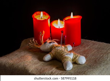 A Voodoo Doll And Candles Are On A Table