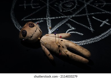 Voodoo Doll Near Ritual Circle Drawn On Black Table