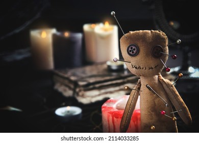 Voodoo doll pierced with pins on table indoors, closeup - Shutterstock ID 2114033285