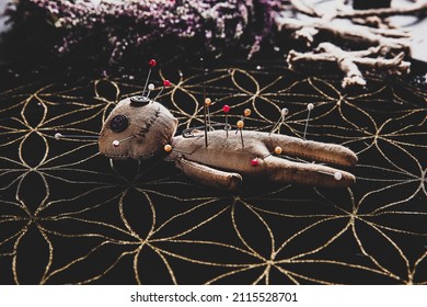 Voodoo Doll Pierced With Pins On Table. Curse Ceremony