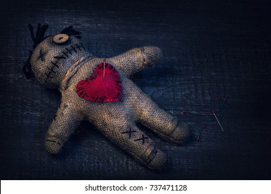 Voodoo doll with pins stuck into it