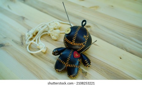 A Voodoo Doll With A Rope On A Wooden Table