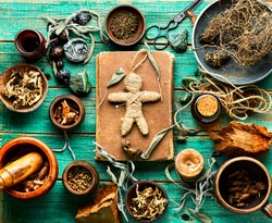 Voodoo Doll,magical Herbs And Witchcraft Attributes On An Old Table