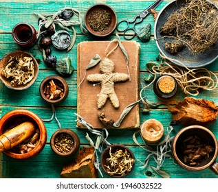 Voodoo doll,magical herbs and witchcraft attributes on an old table