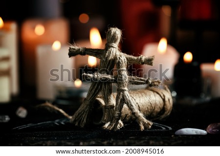 Voodoo dolls on table in dark room. Curse ceremony
