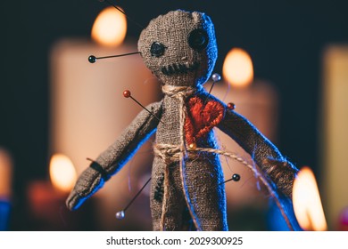 Voodoo Magic concept. Witchcraft with Voodoo doll. Close-up of rag puppet nipped with needles