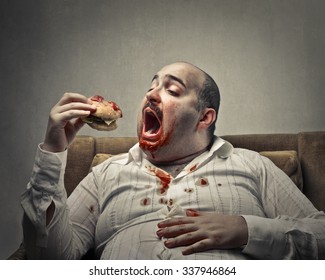 Voracious man eating a hamburger