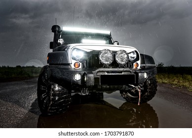 Vorkuta, Komi / Russia - 13 07 2019: Jeep Rubicon Wrangler Car in the rain at dusk in the Far North in the tundra